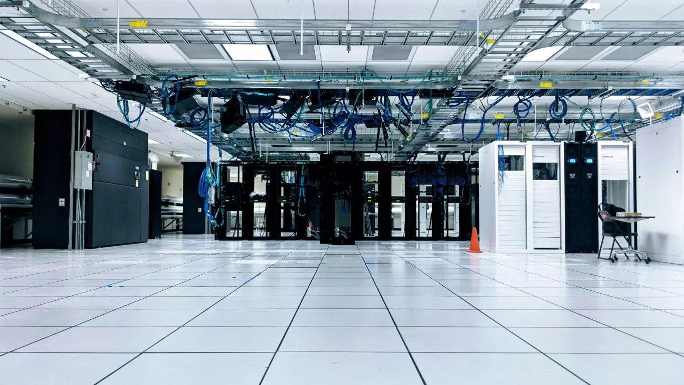 Server room with blue cords representing web hosting