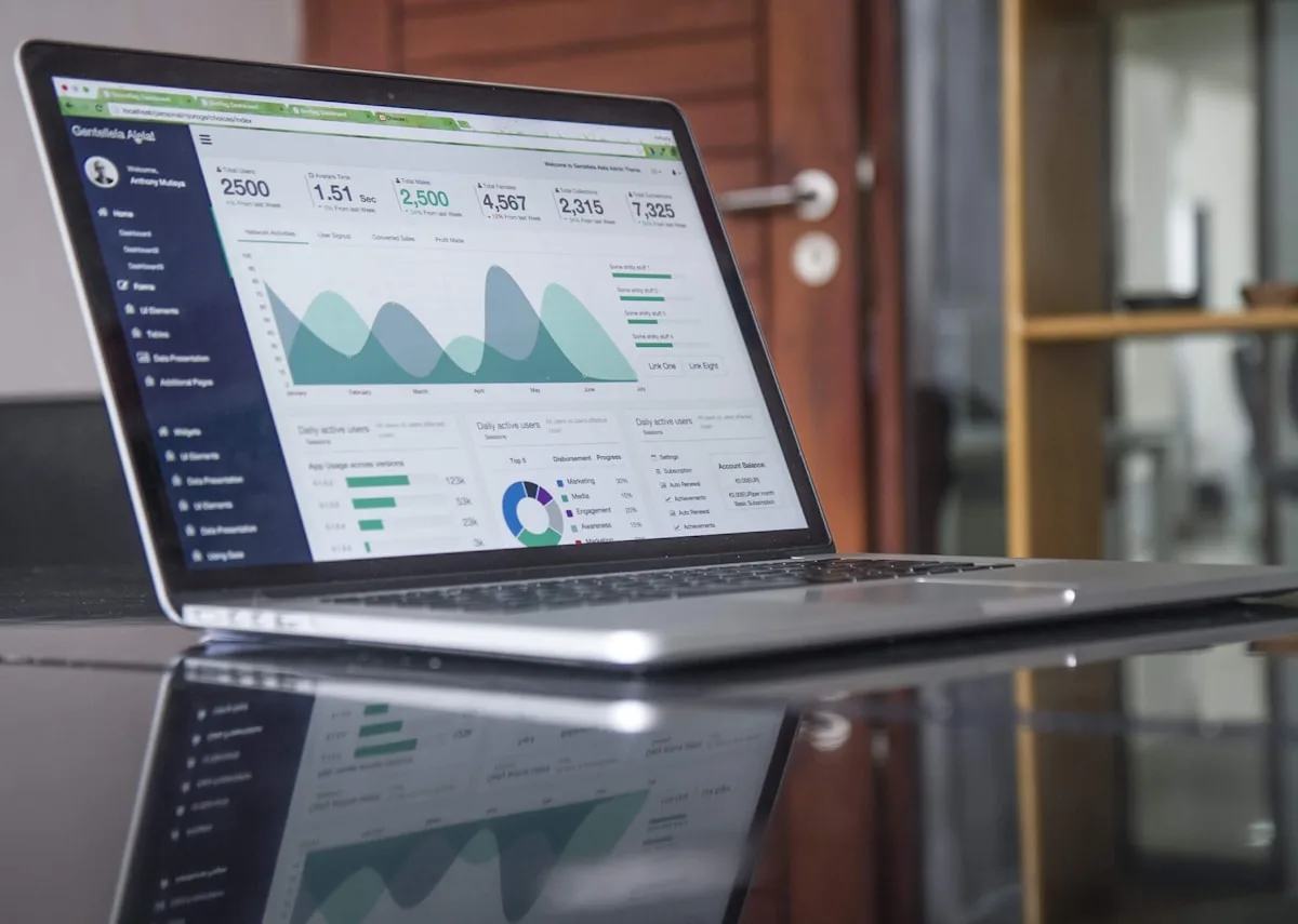 Monthly website management fee analysis on laptop with analytics dashboard